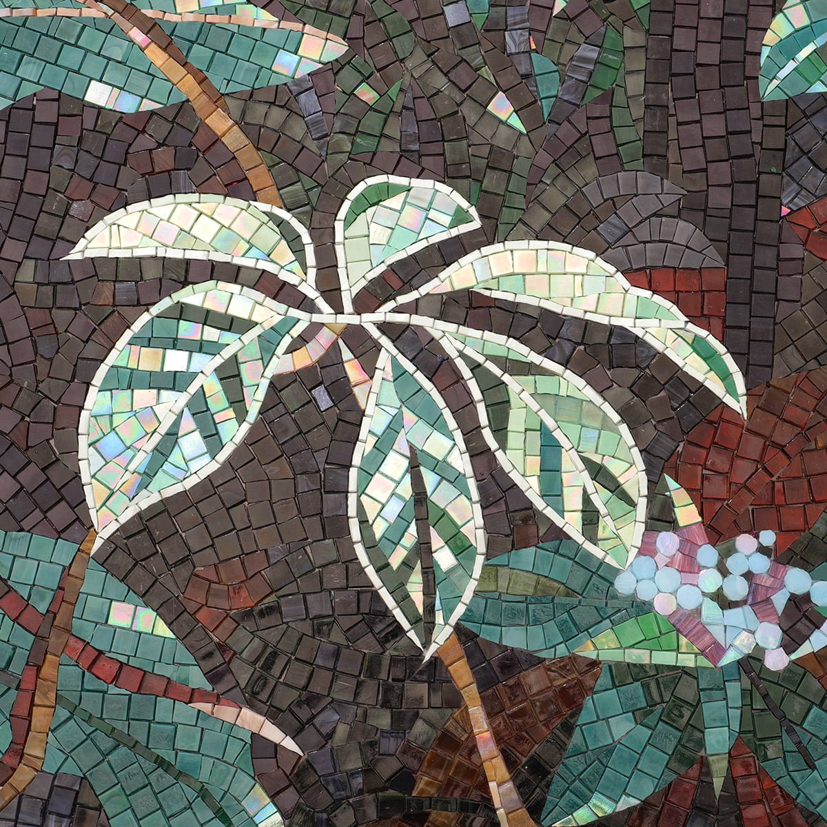 Close-up of a mosaic mural showing iridescent green and white leaves against a dark forest background.