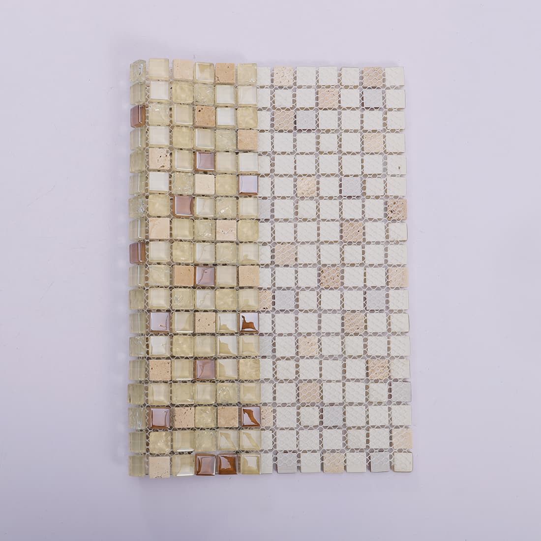 Front face and mesh backing of a beige mosaic tile sheet.