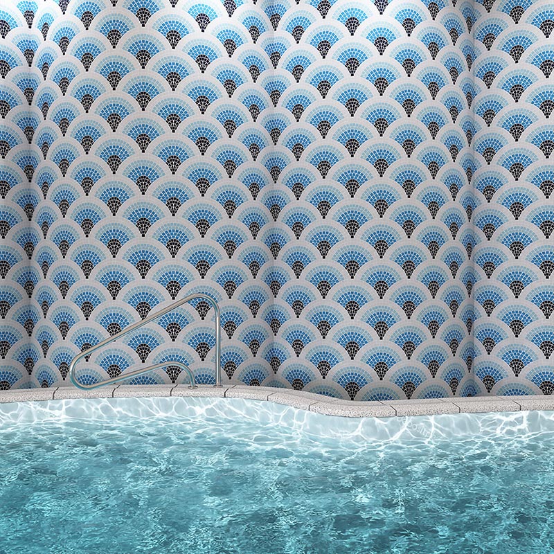 Indoor pool wall finished with blue, black, and white geometric fan mosaic tiles
