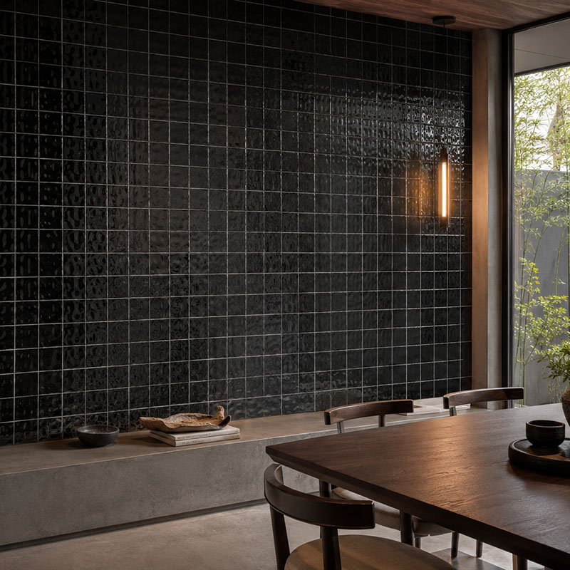 Glossy black contemporary wall tiles covering a sophisticated dining room feature wall