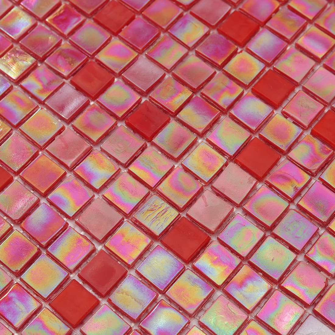 Close-up of glossy iridescent red square glass mosaic surface