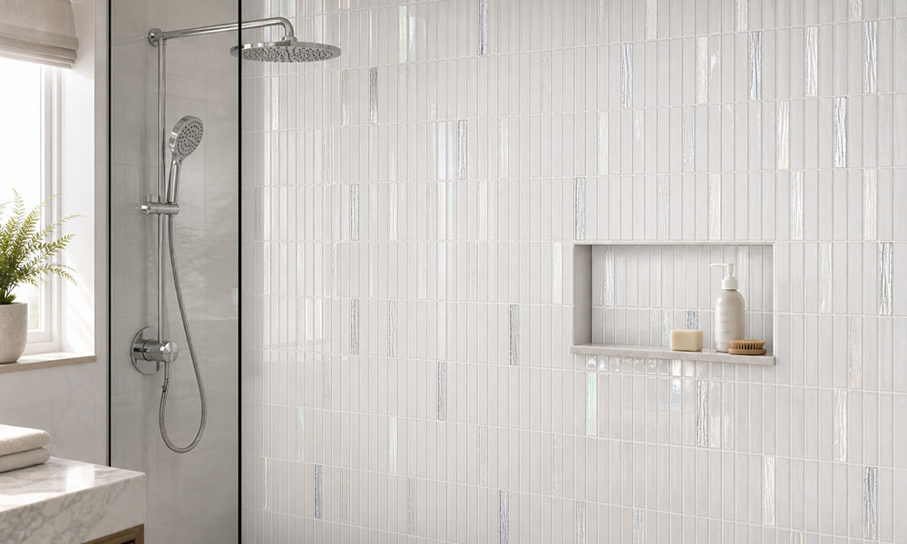 Glossy white vertical shower tiles with iridescent accents and built in niche