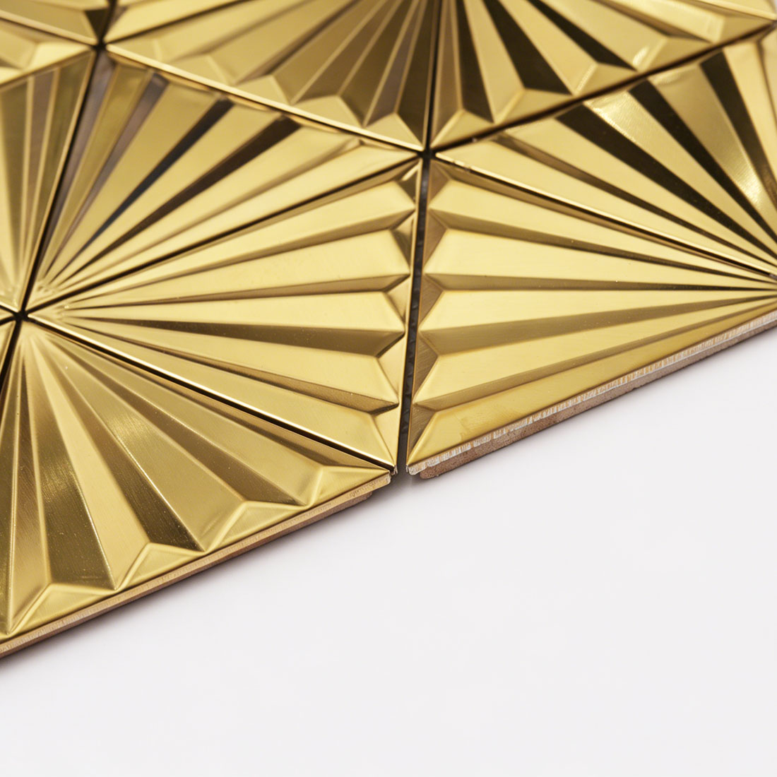 Side detail of gold 3D triangle metal mosaic showing tile thickness