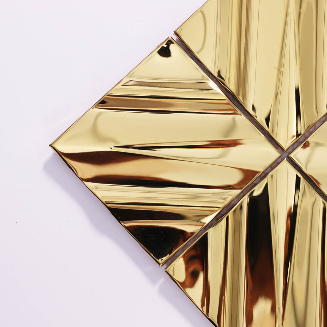 Close-up of gold diagonal square stainless steel mosaic tile corner