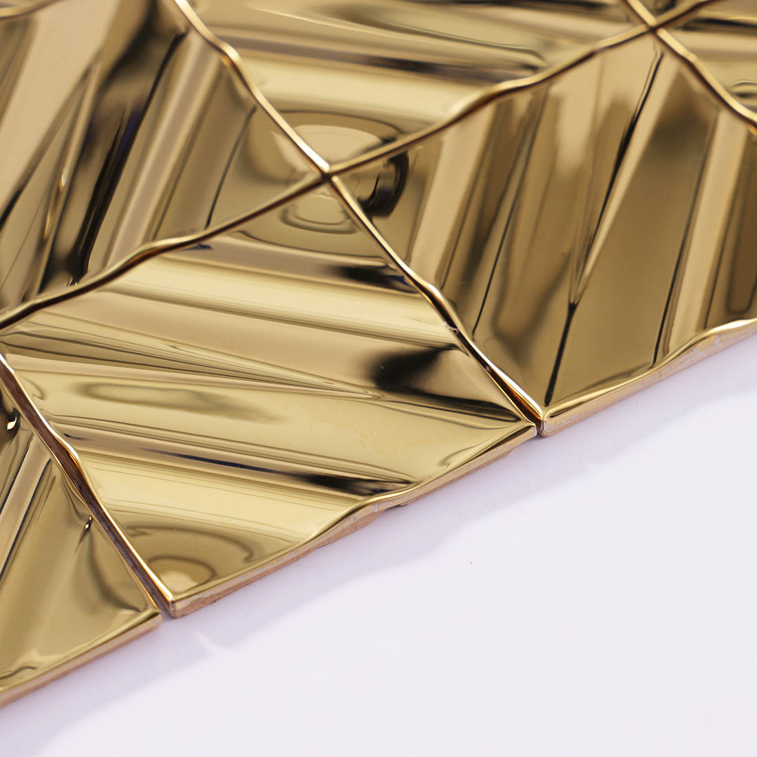 Edge detail of gold diagonal square stainless steel mosaic tile sheet