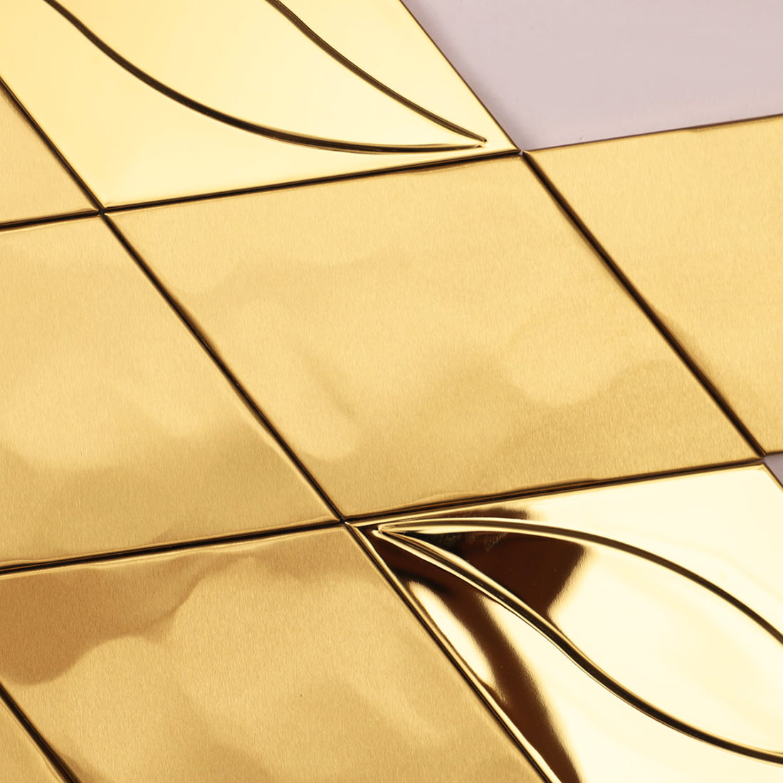 Close-up showing the textured hammered surface of gold diamond metal tiles.