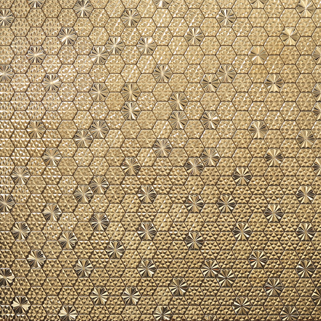 Full wall view of gold embossed hexagon metal mosaic tiles