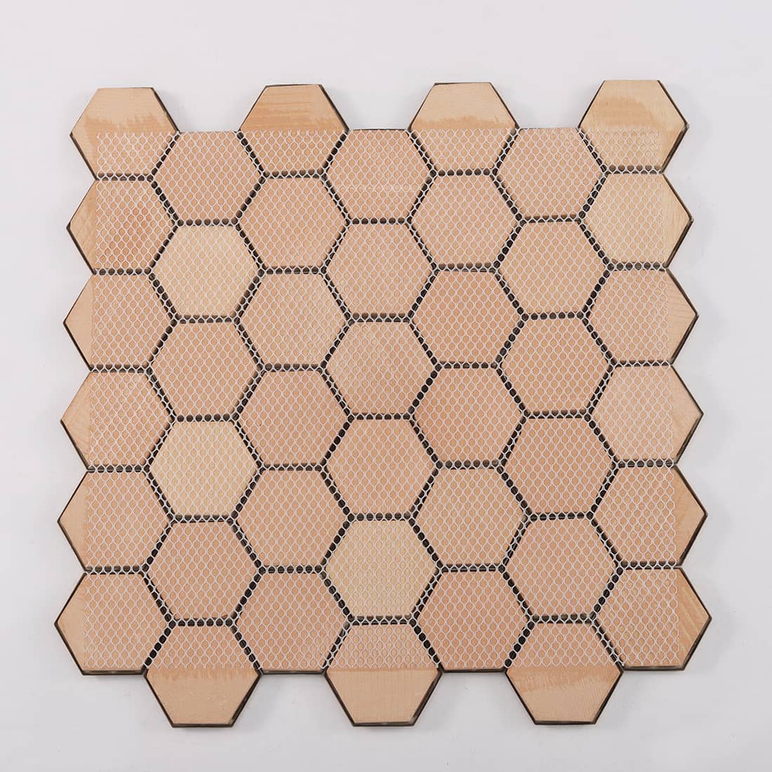 Back view of gold embossed hexagon metal mosaic tile with mesh backing