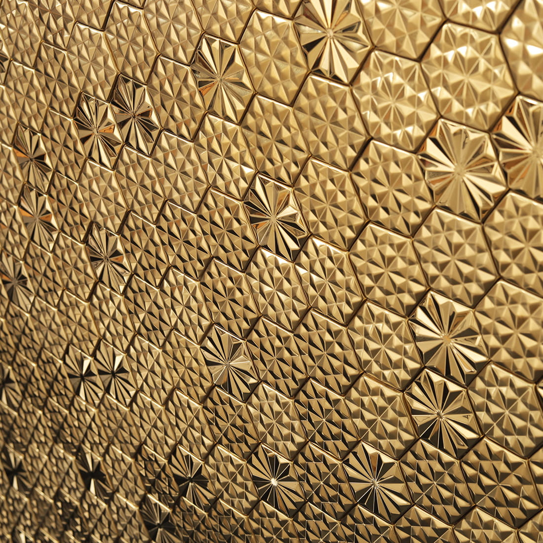 Close-up wall view of gold embossed hexagon metal mosaic tiles