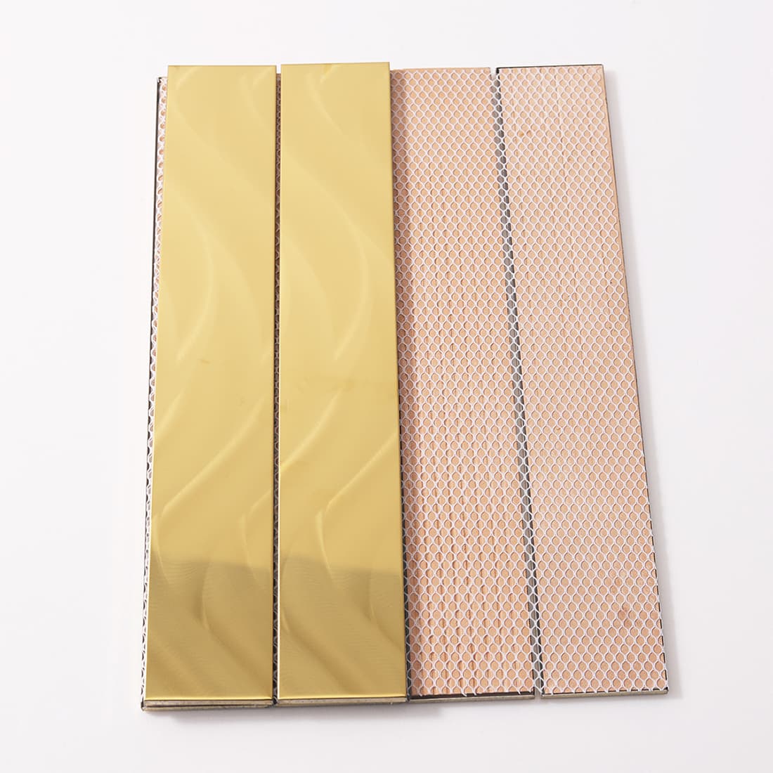 Front and back of gold flowy tiles showing the installation mesh backing.