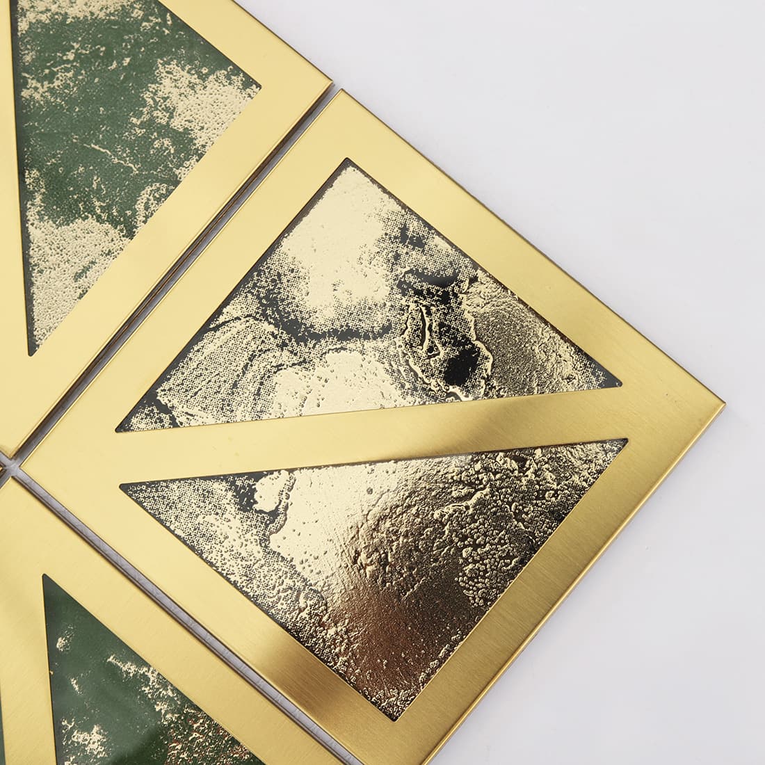 Close up of gold framed square mosaic with silver and black textured glass