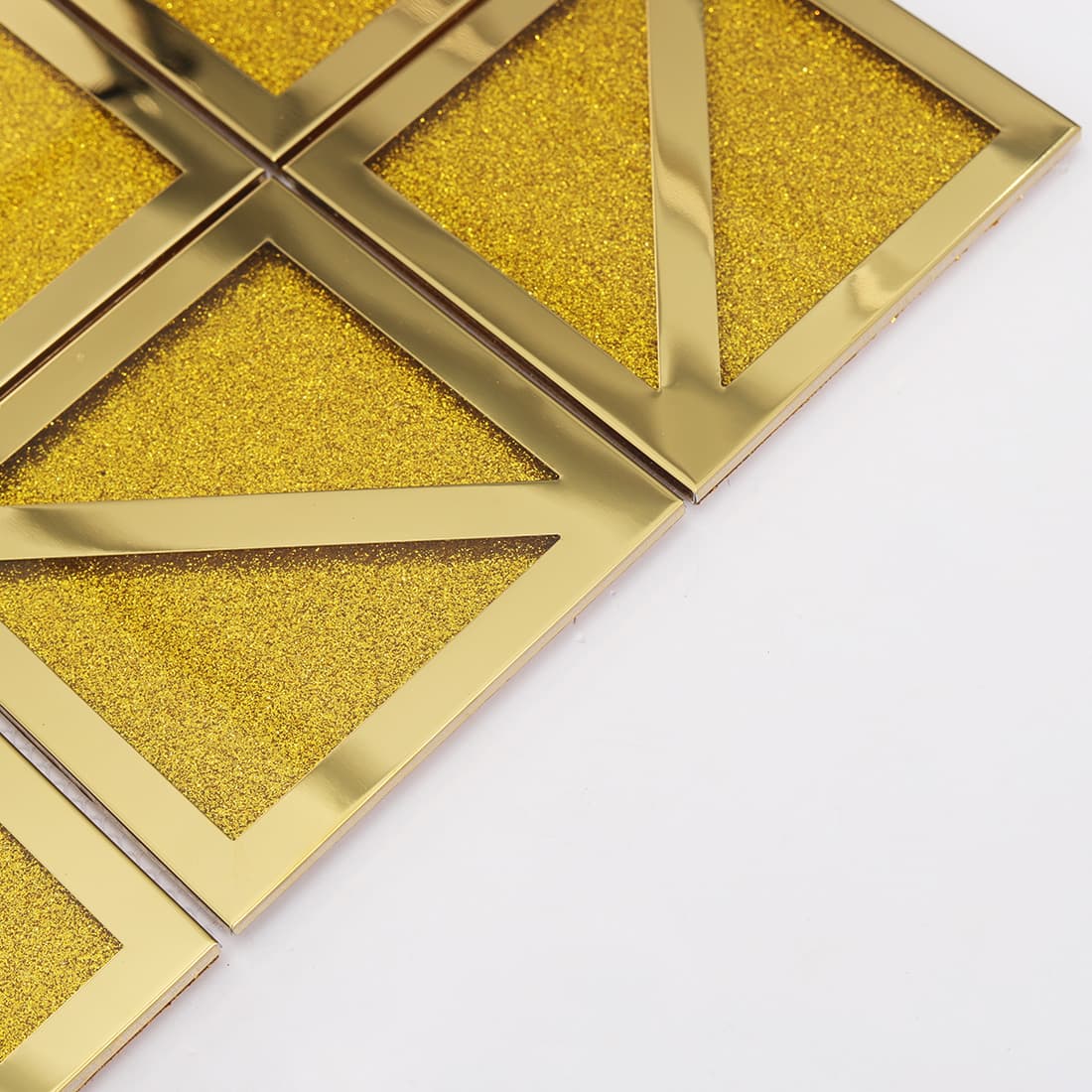 Edge detail of gold square mosaic tile with glitter center and diagonal pattern