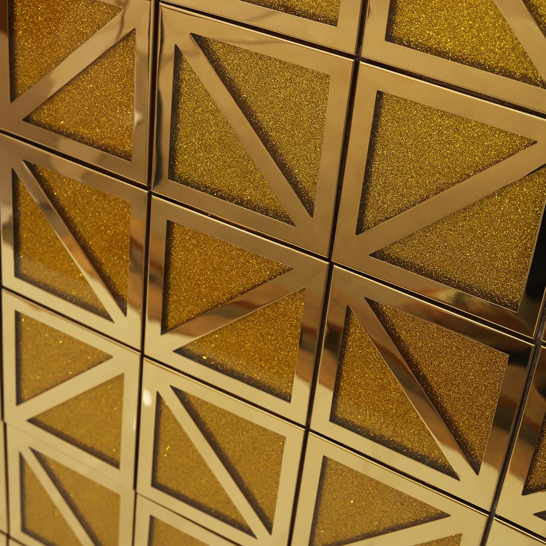 Close-up of installed gold glitter square mosaic wall with diagonal accents