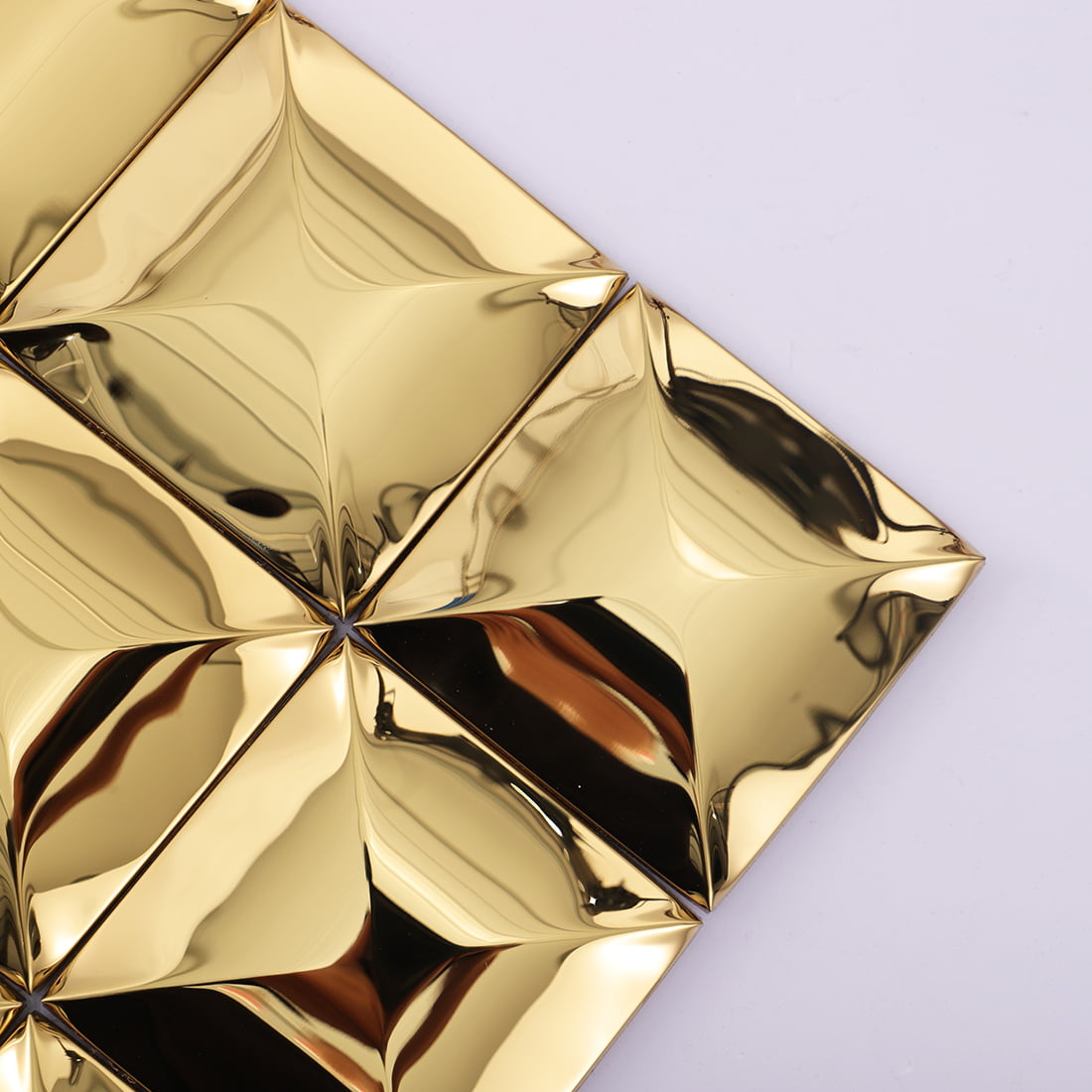 Corner detail of gold glossy square 3D metal mosaic tile