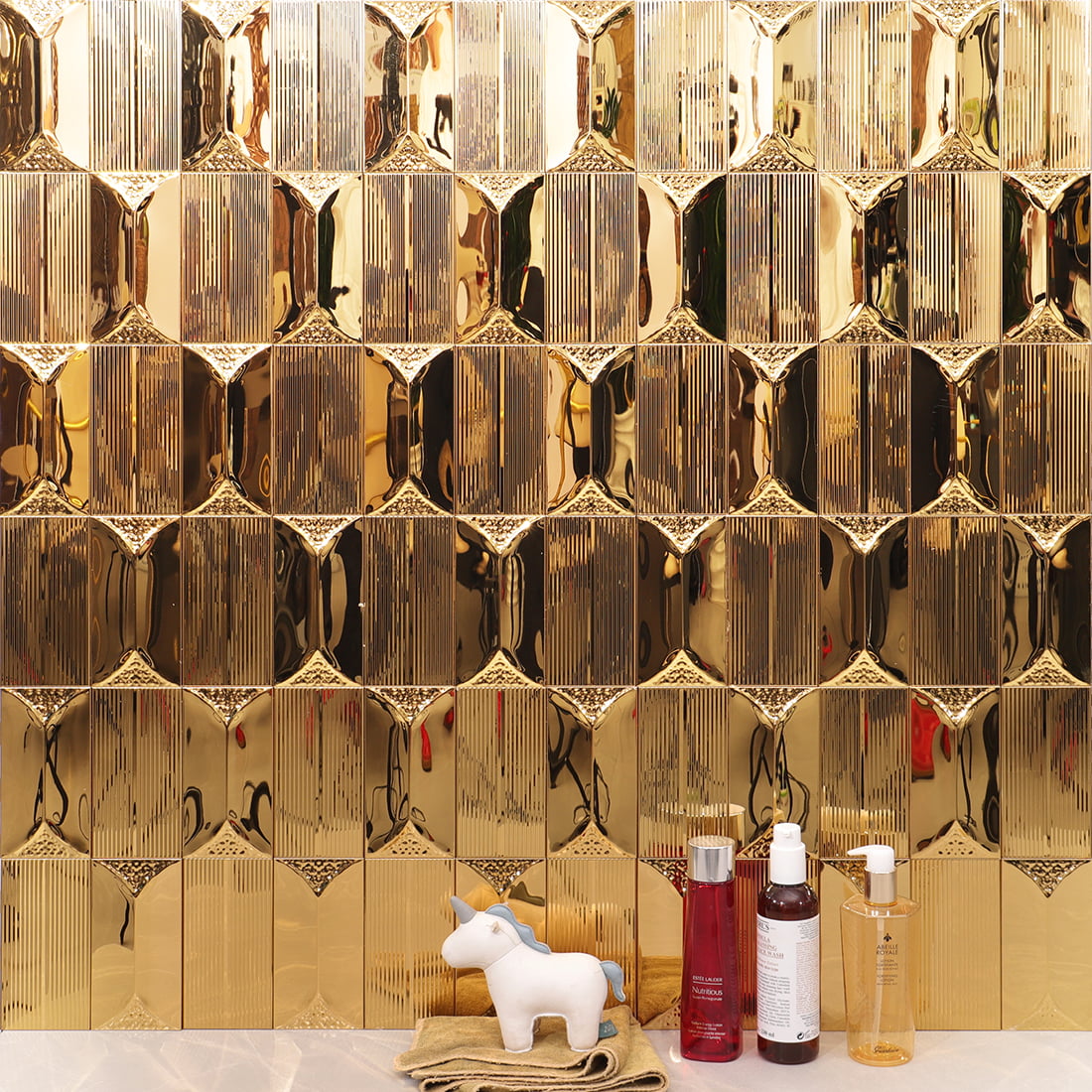 Gold glossy and textured rectangular metal mosaic tile installed on wall