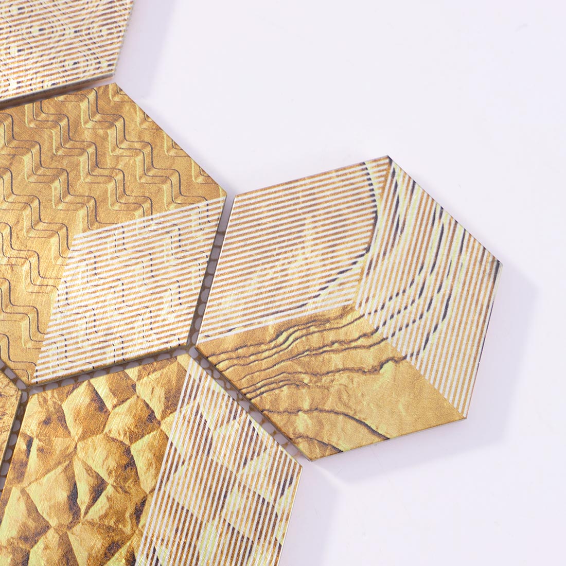 Close-up detail of gold patterned hexagon aluminum mosaic tile