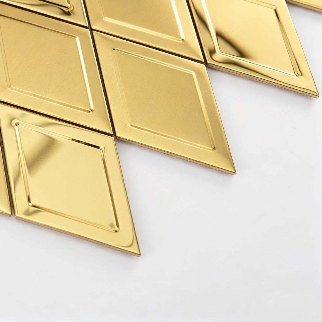 Side view of gold rhombus stainless steel mosaic showing the layered tile base