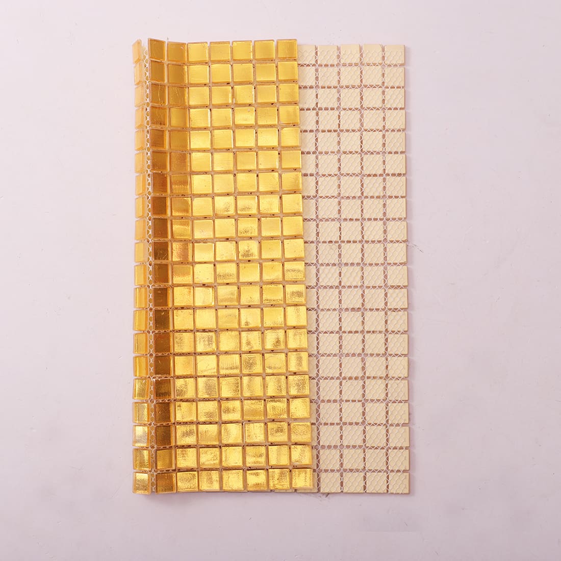 Back view of gold square foil glass mosaic tile with mesh backing