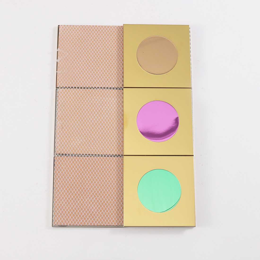 Gold square metal tile showing mesh back and colorful circular front inserts
