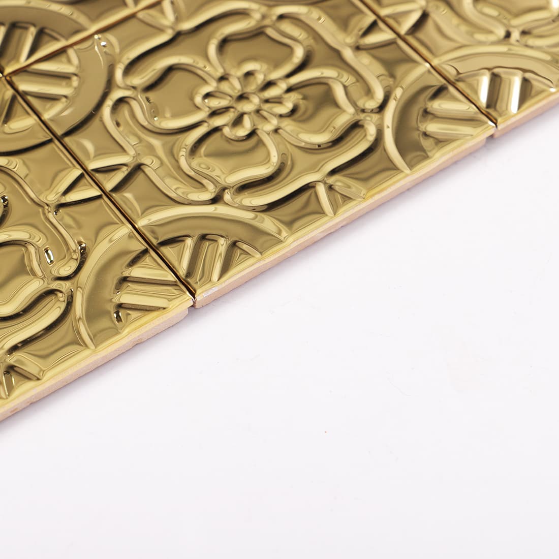 Side view of gold stainless steel embossed floral mosaic tiles