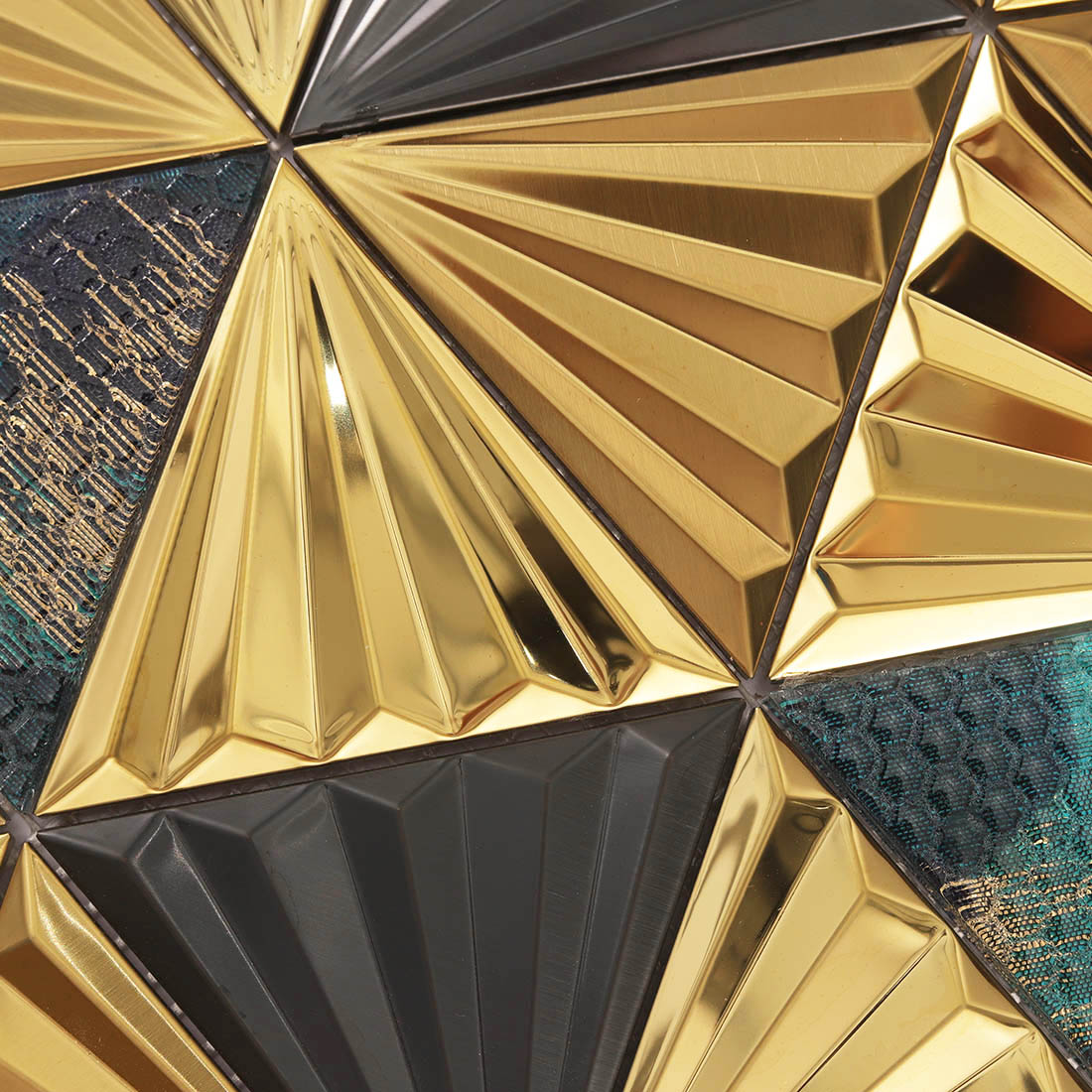 Macro view of 3D gold fan triangle stainless steel mosaic with teal patterned glass
