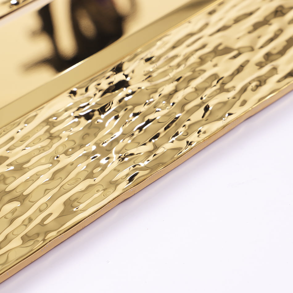 Gold textured metal tile edge and surface detail