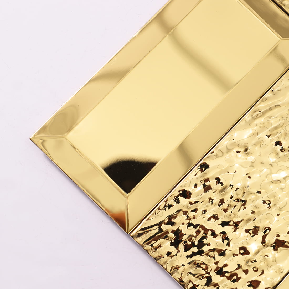 Corner detail of gold textured rectangular metal mosaic tiles