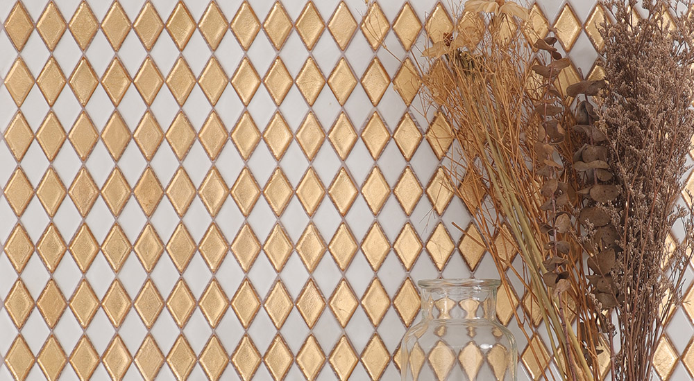 {"default":"Close up of textured gold and white diamond mosaic wall tiles."}
