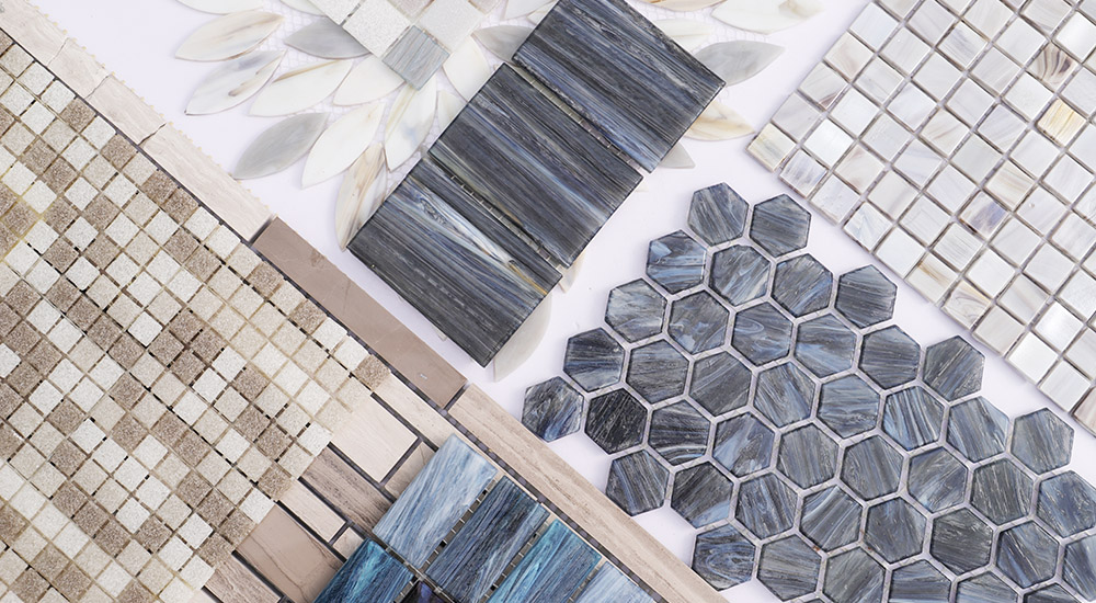{"default":"Collection of gray hexagon mosaics, water glass, and wood grain marble tiles."}

