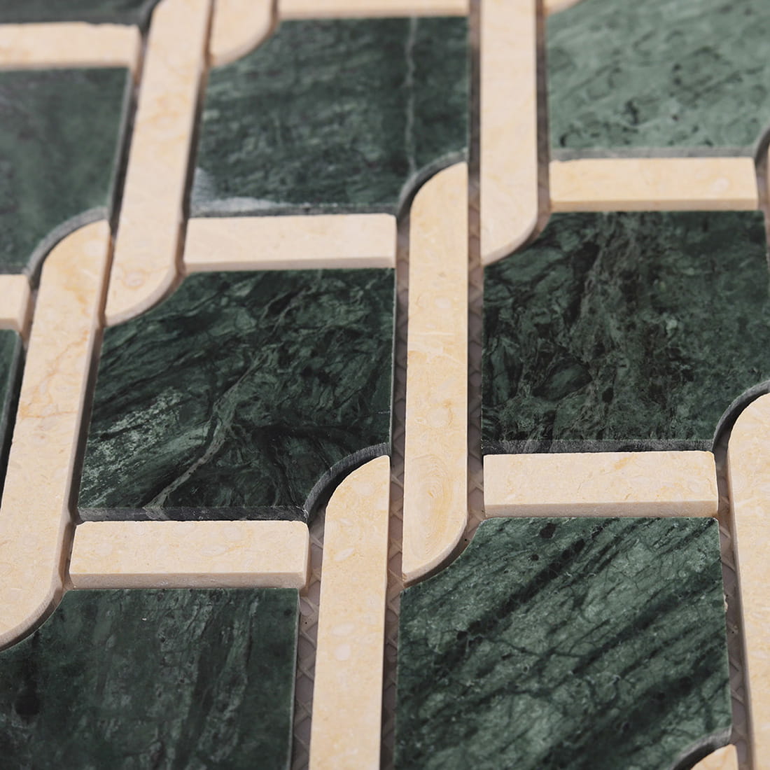 Close up view of green and beige marble chain link mosaic tile pattern