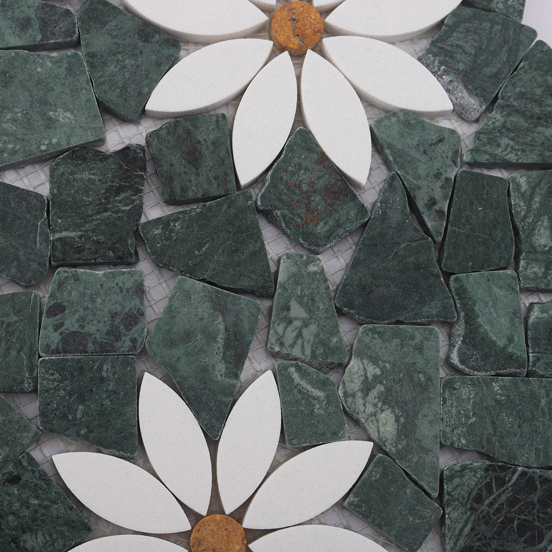 White flower pattern set in green irregular pebble marble mosaic