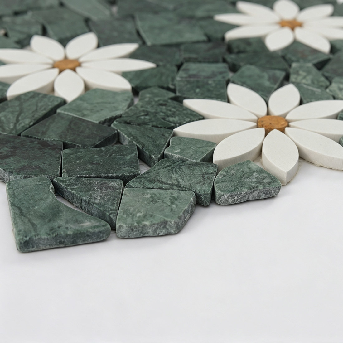 Close-up of green irregular pebble and white floral marble mosaic