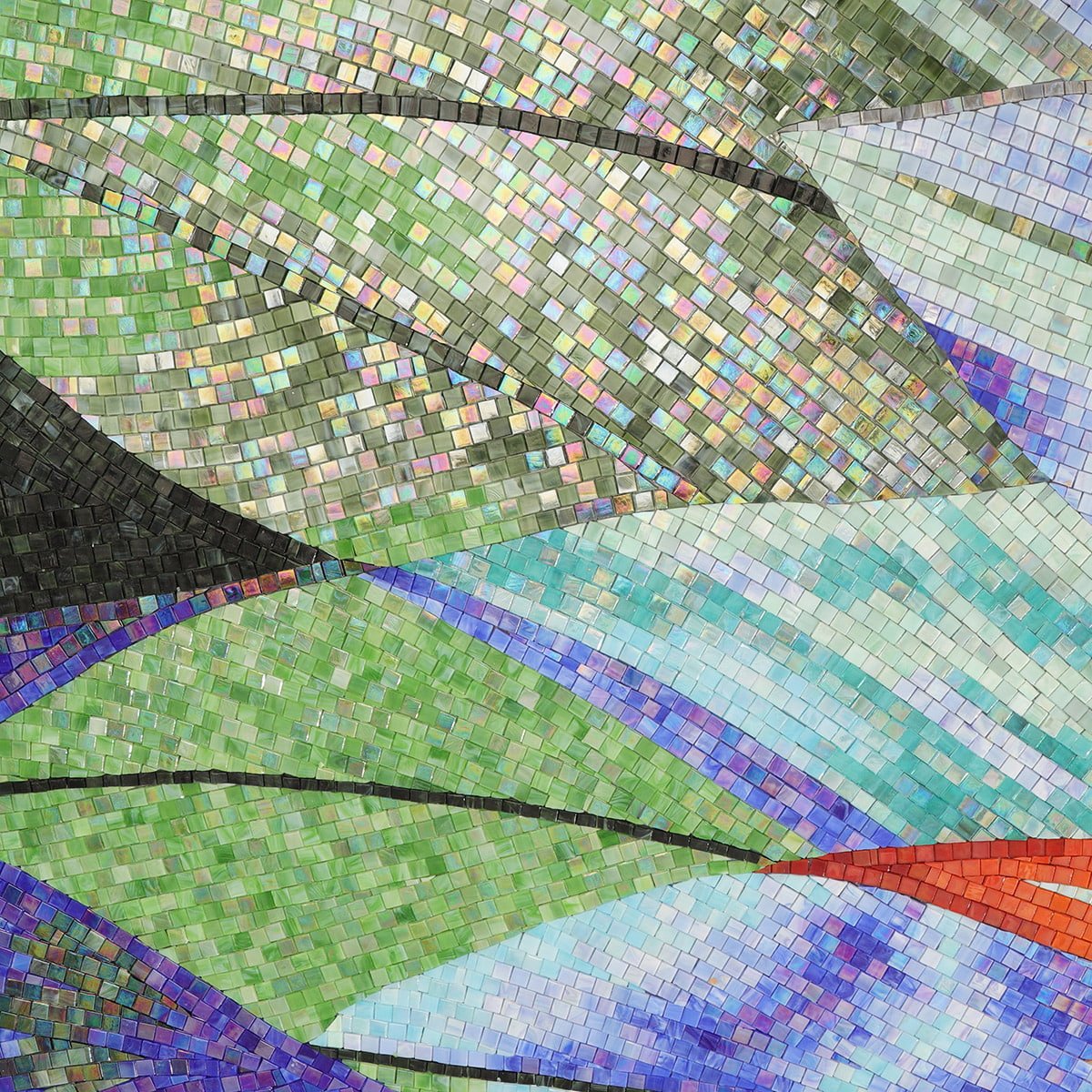 Close-up of handmade green leaf mosaic with iridescent glass tiles