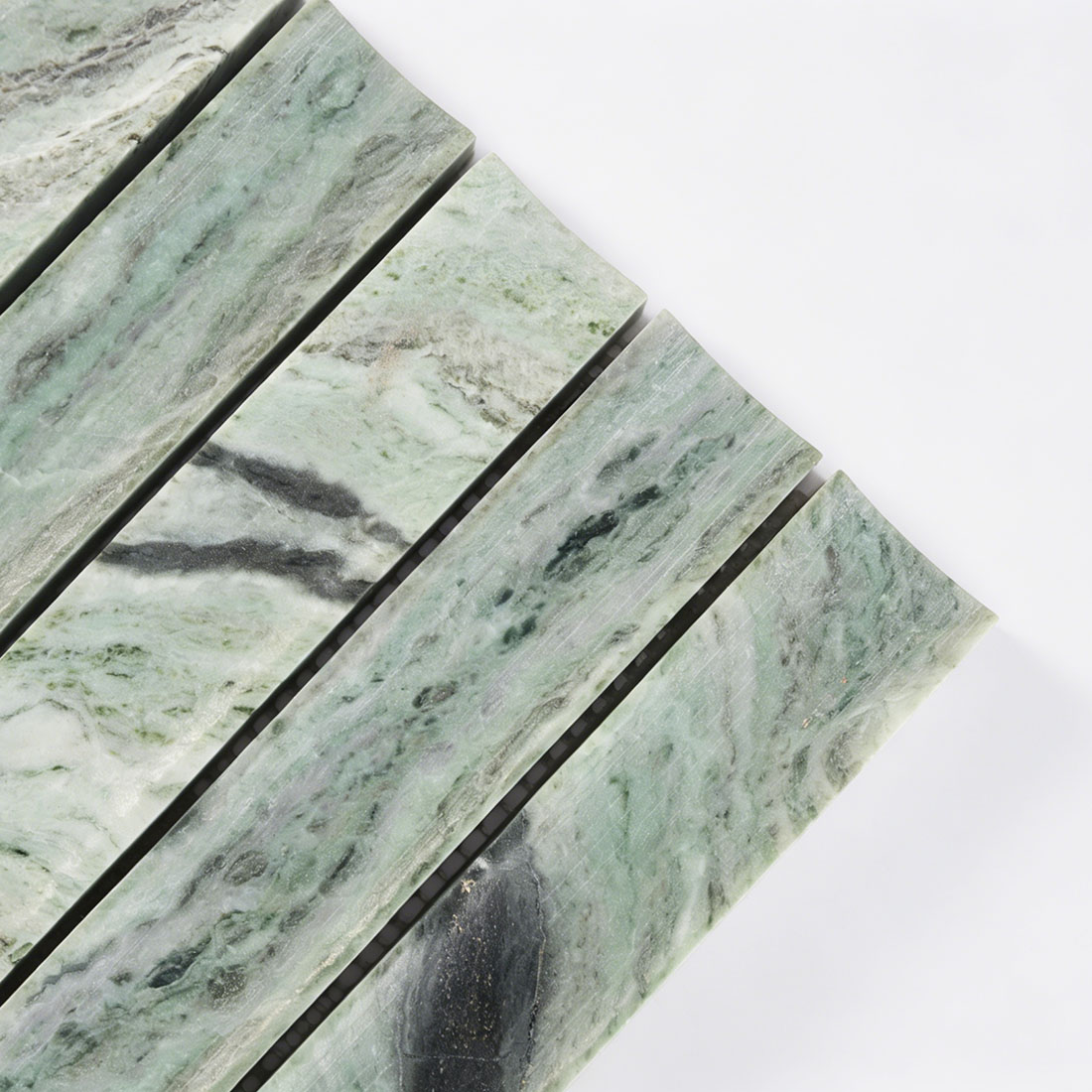 Corner detail of curved green marble fluted tile.