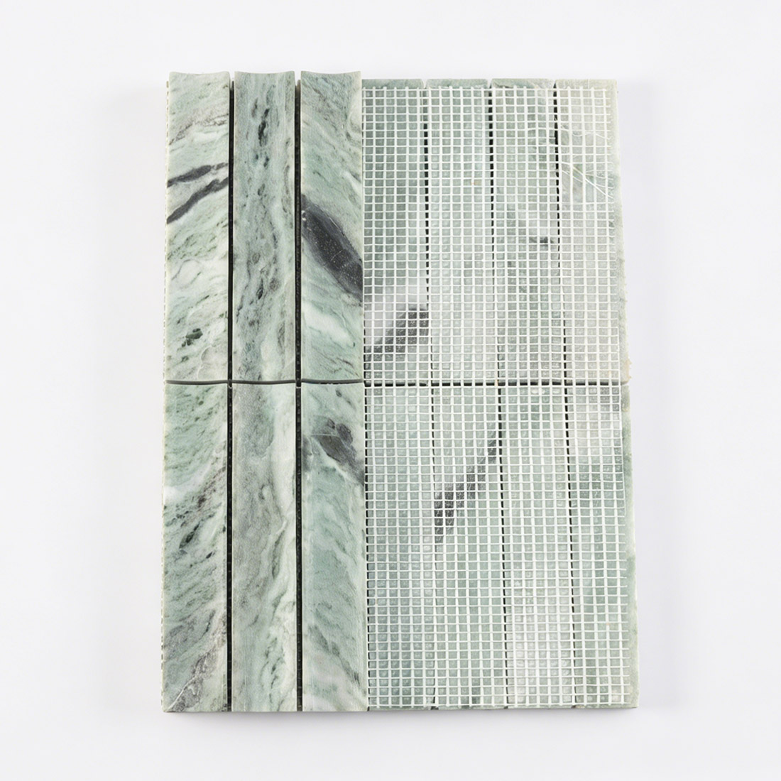 Mesh backing on green marble fluted stacked tile.