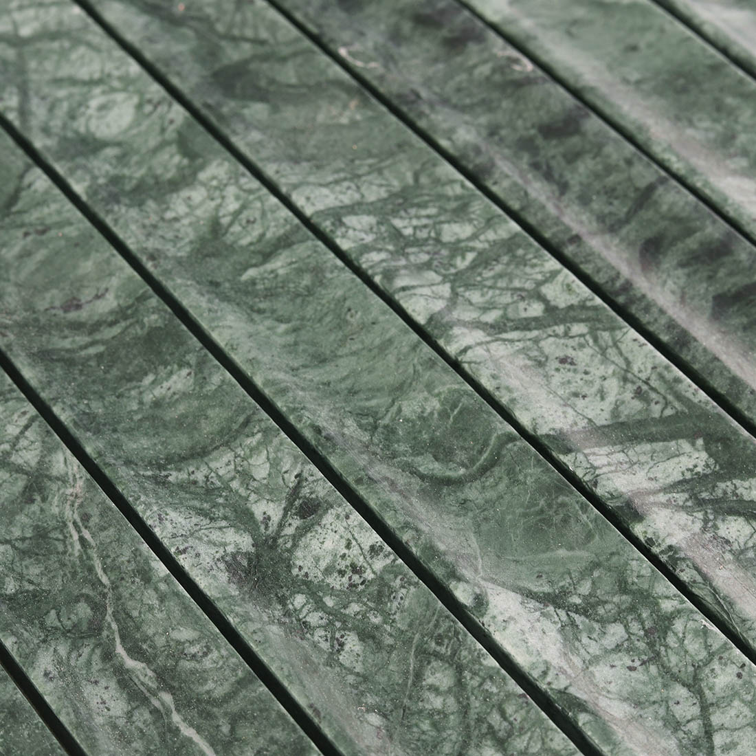 Detailed surface texture showcasing dark veins in emerald green marble.