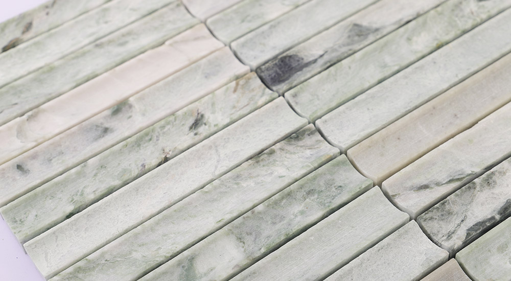 {"default":"Green marble fluted tiles with natural veining and a decorative concave surface."}
