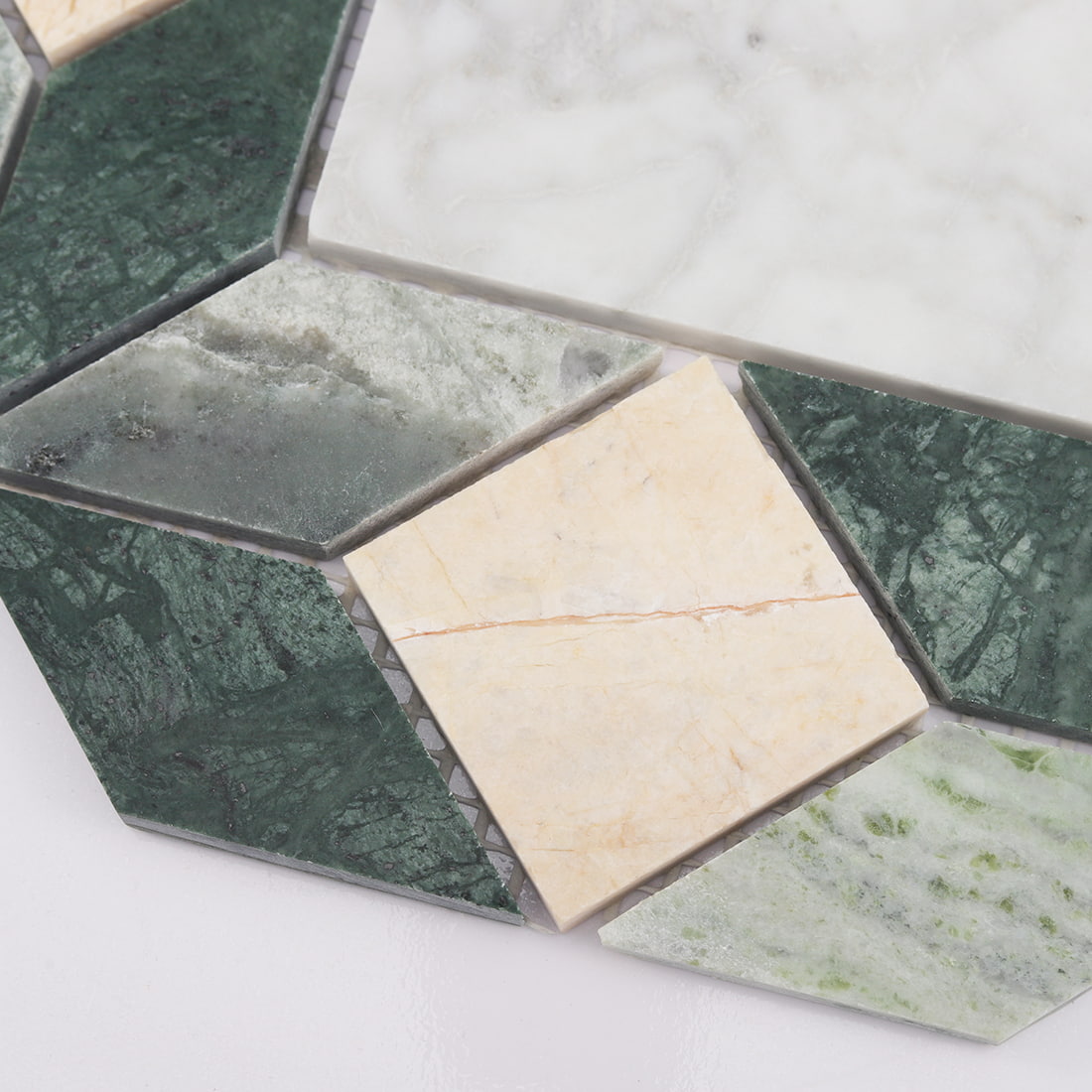 Close-up of green beige and white marble geometric mosaic tile corner