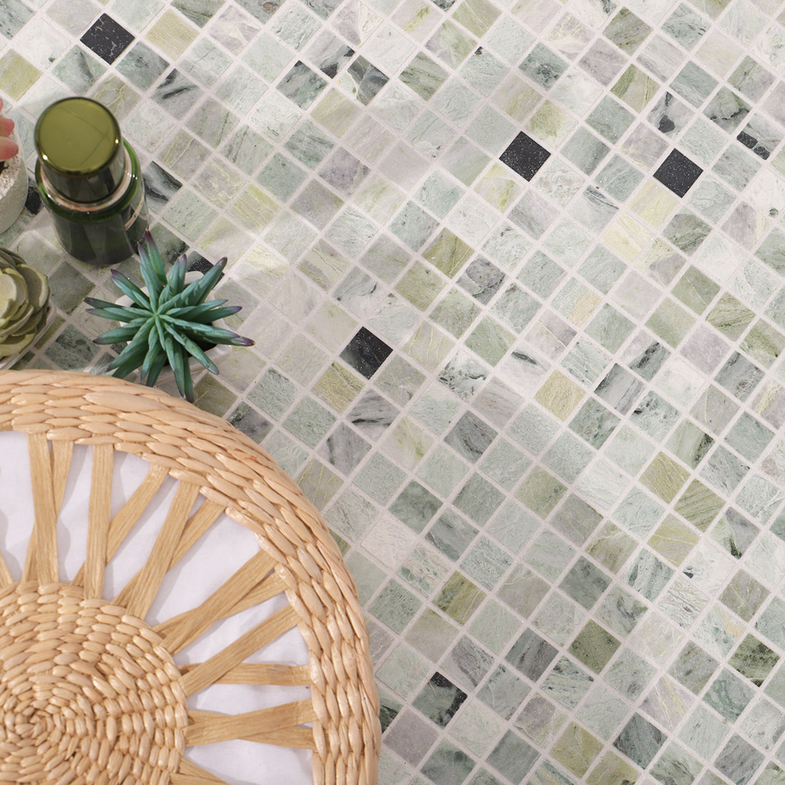 Green marble mosaic tile bathroom styling with basket and plants decor scene.