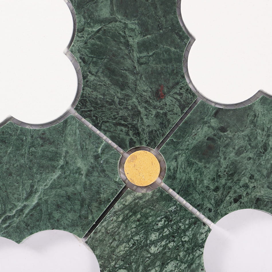 Green marble mosaic detail with small gold round accent and curved cut edges