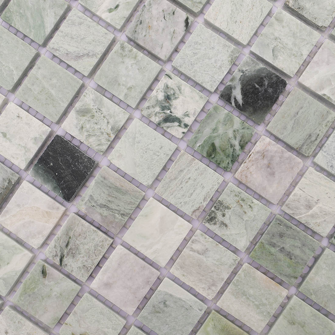 Close-up green marble mosaic tiles showing dark stone texture variation.
