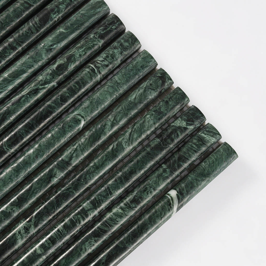 Close-up corner detail showing natural veins of green marble tile.