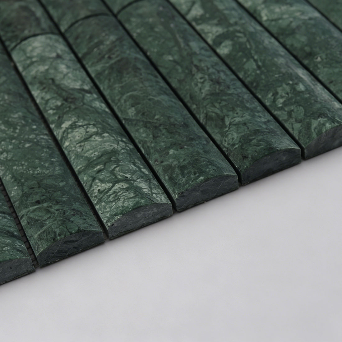 Edge profile of green marble rounded flute tile showing raised surface