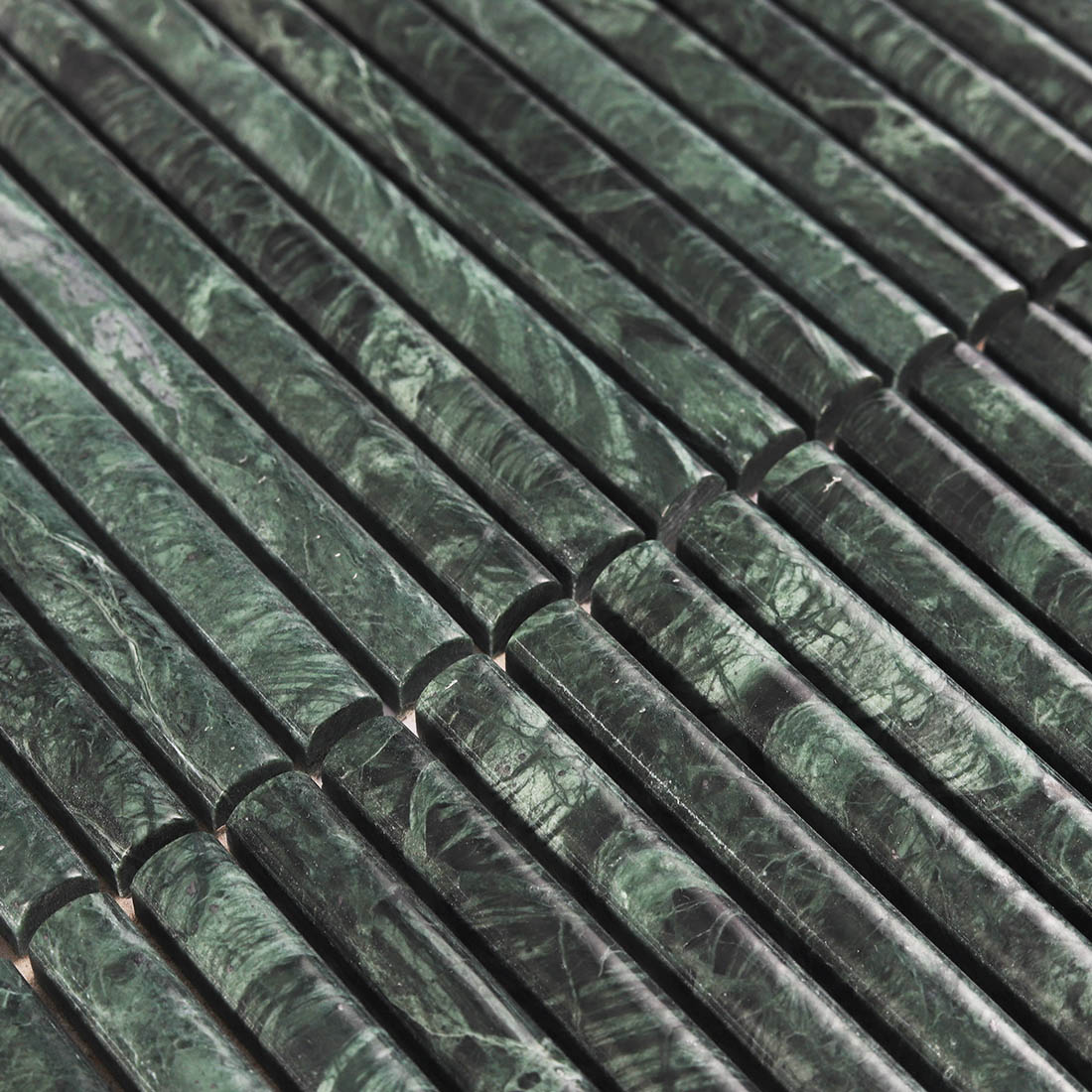 Detailed surface texture showing intricate white veins in green marble.