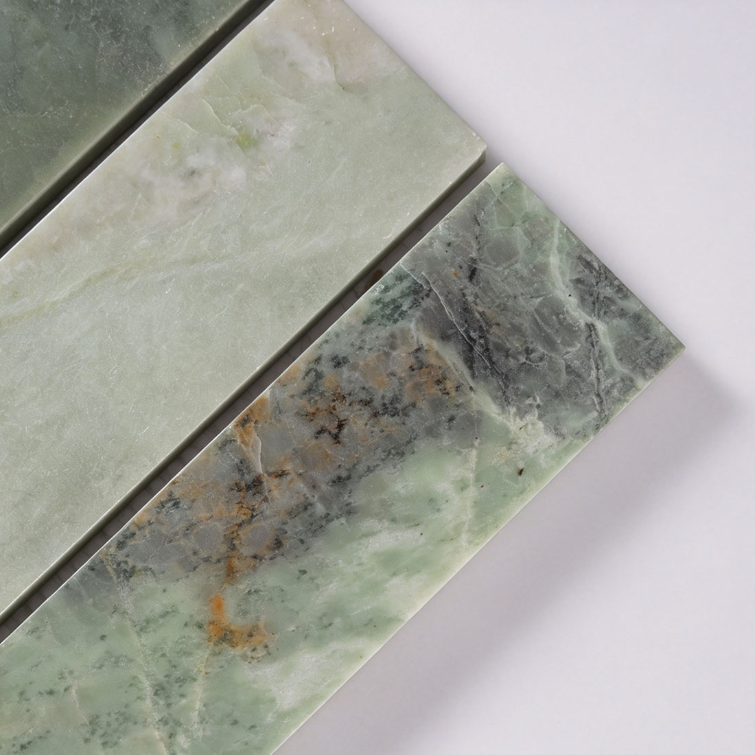 Close-up texture of green marble strip tile with natural veining