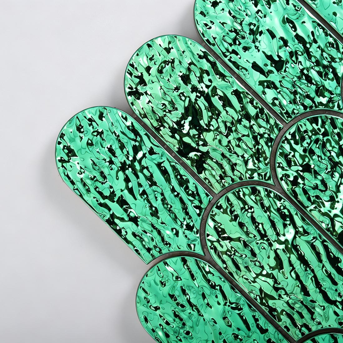 Close up of green scallop metal mosaic tile individual chips texture