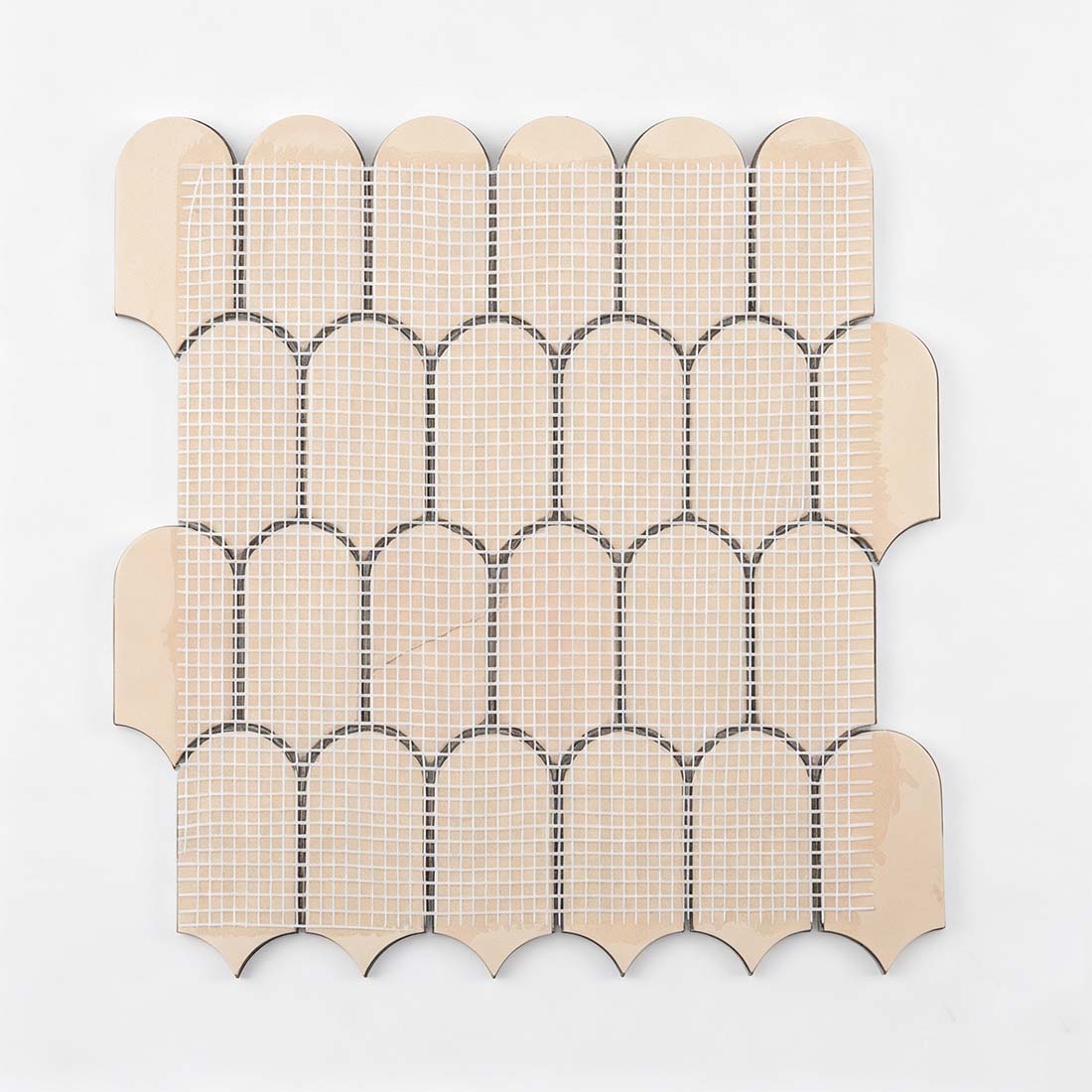Fiberglass mesh backing on reverse side of green scallop metal tile