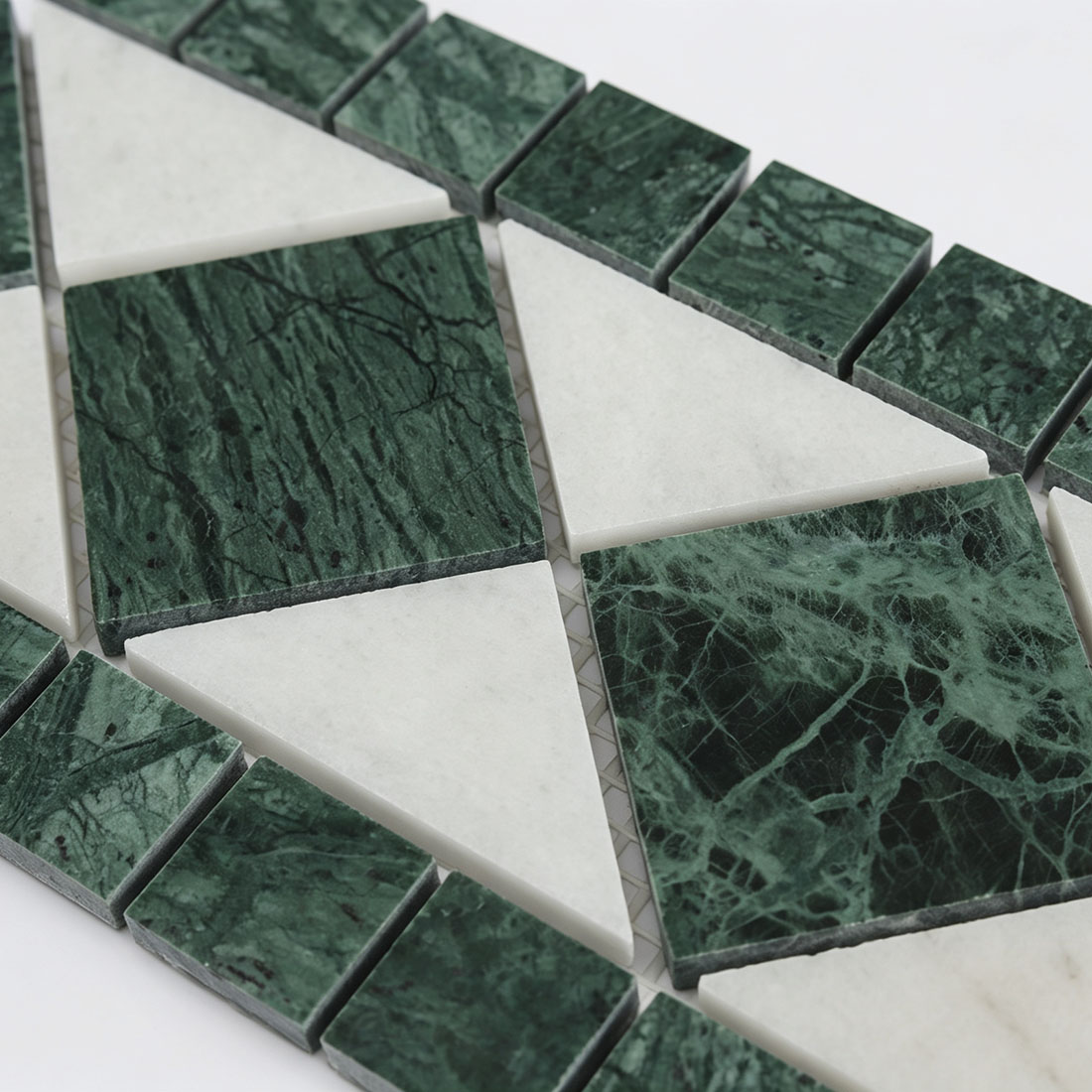 Close-up of green white geometric marble mosaic border pattern