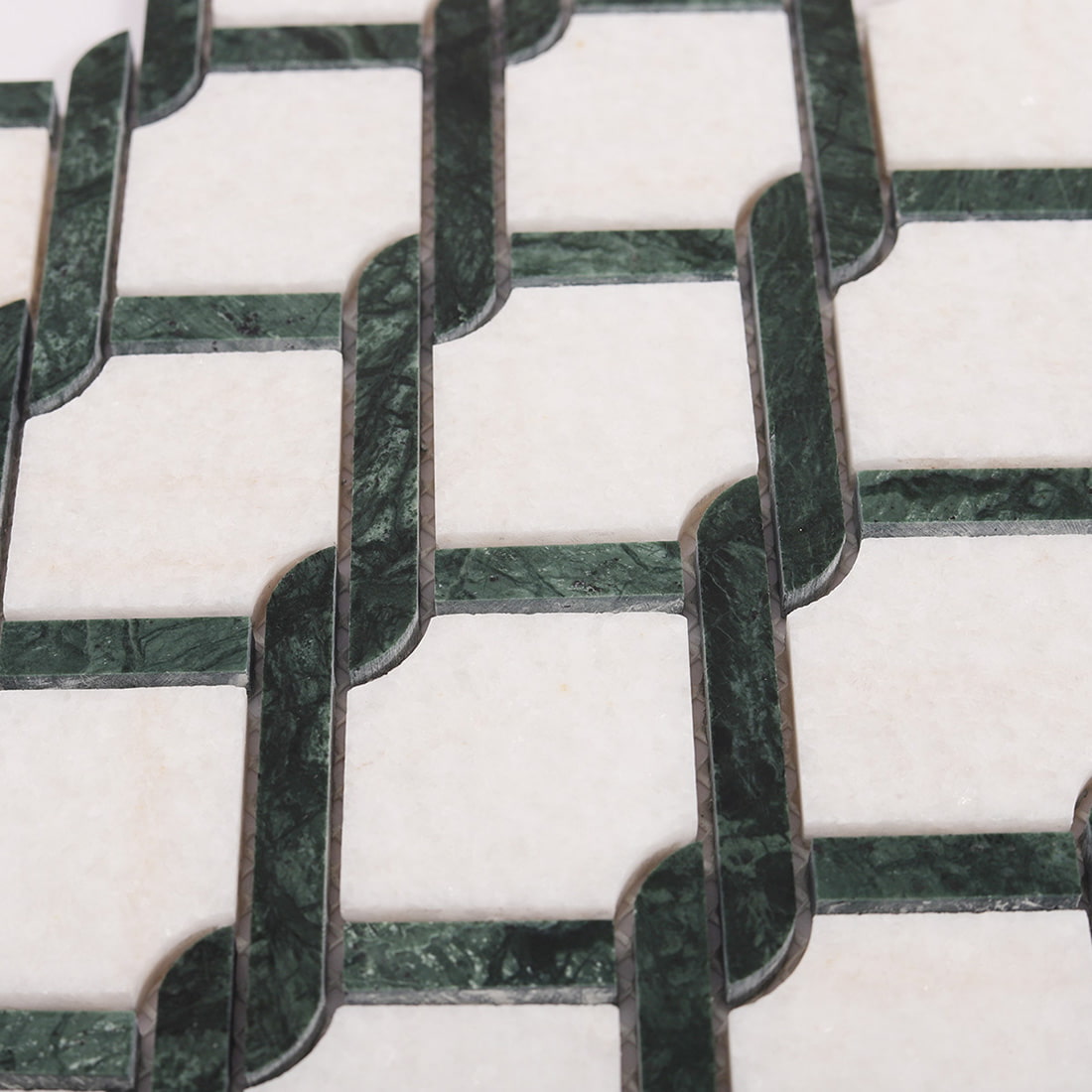 Detailed view of green and white marble mosaic tile surface texture