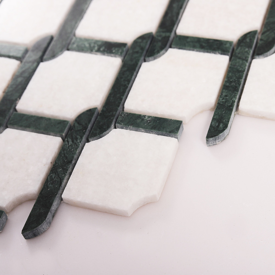 Side angle view of green and white marble mosaic tile showing thickness